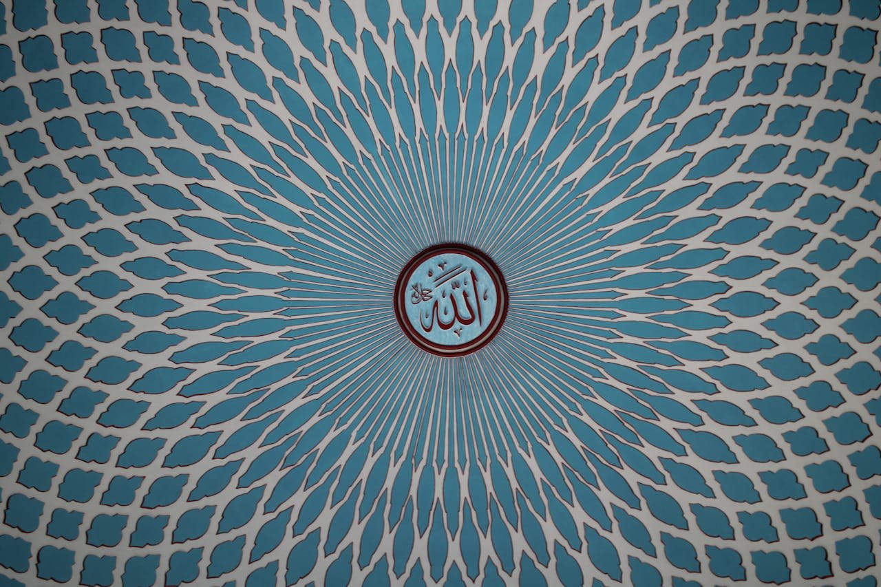 Beautiful Islamic ceiling pattern with blue geometry and central calligraphy symbol.